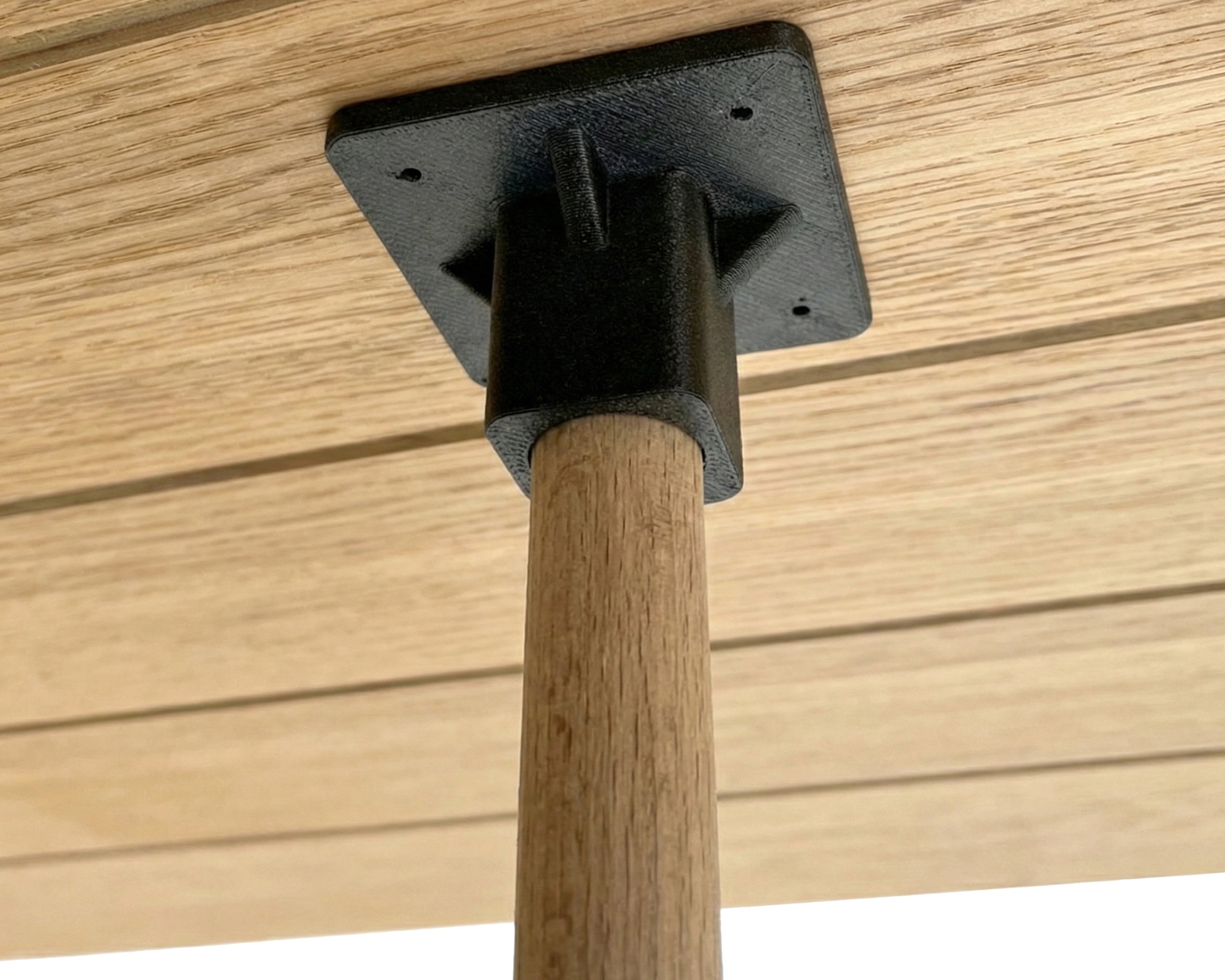 Wooden post with a plastic bracket attached to a wooden surface