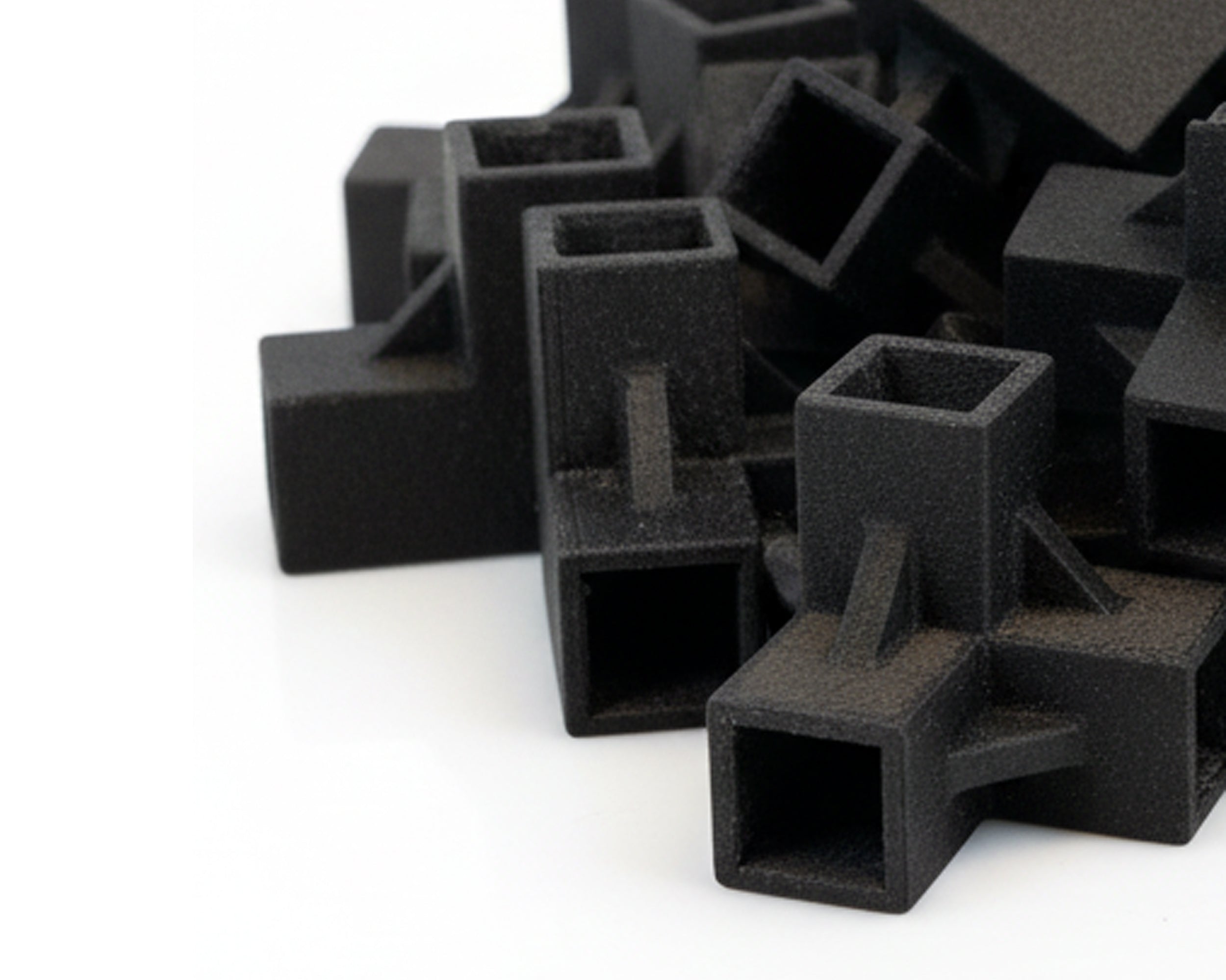 Stack of black square-shaped objects on a white background