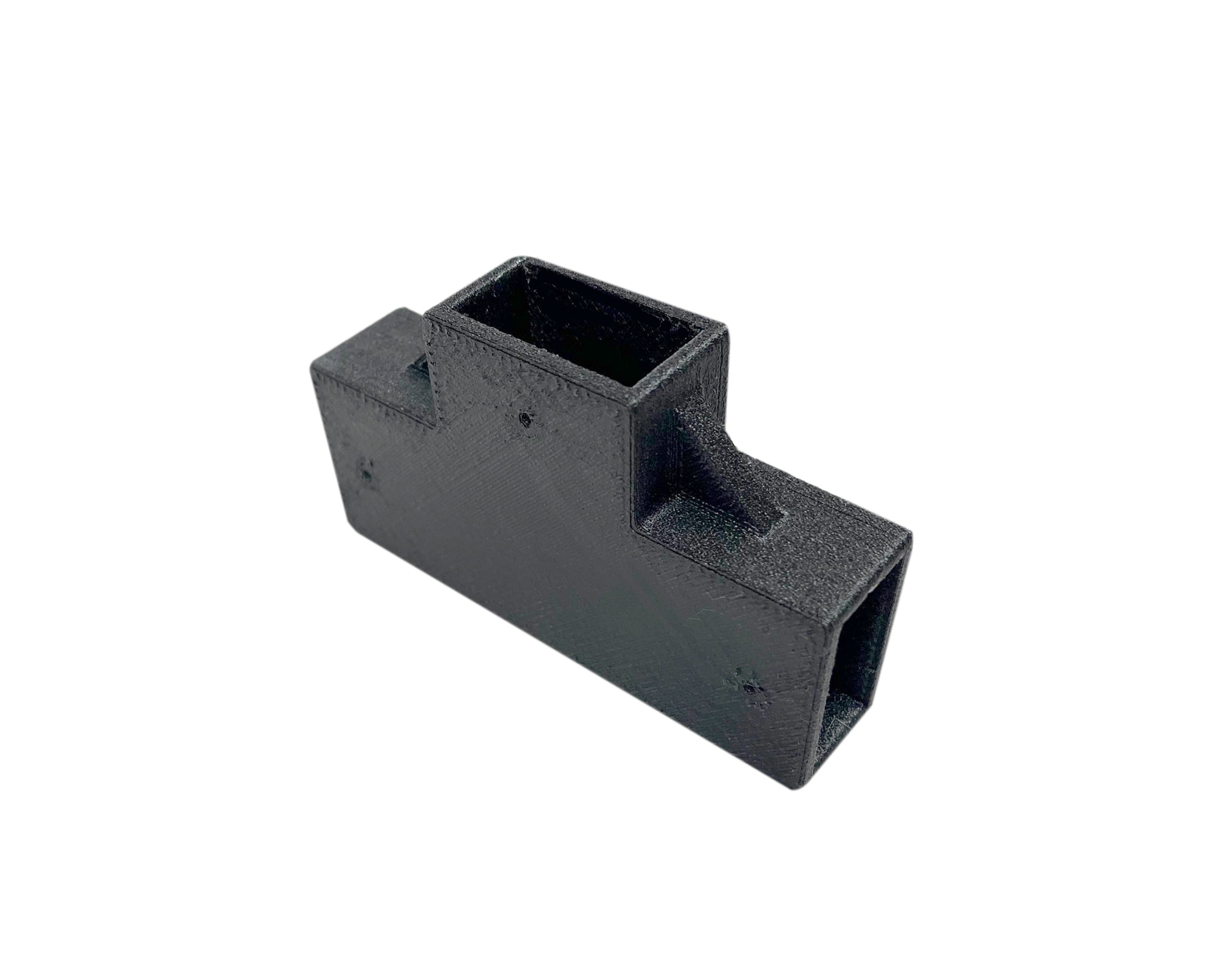 Black plastic component on a white background